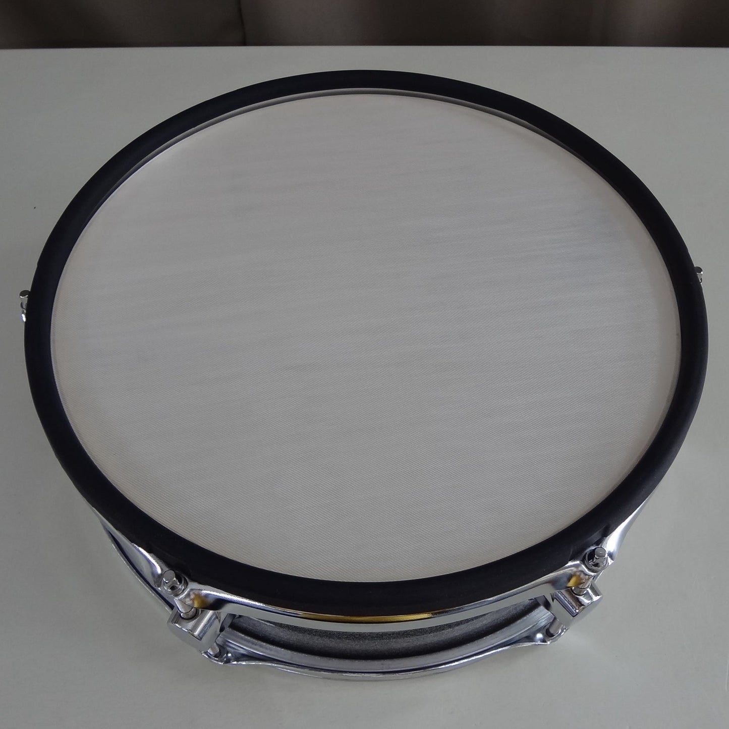 Top down rim view of new 13 inch custom electronic snare drum silver sparkle wrap