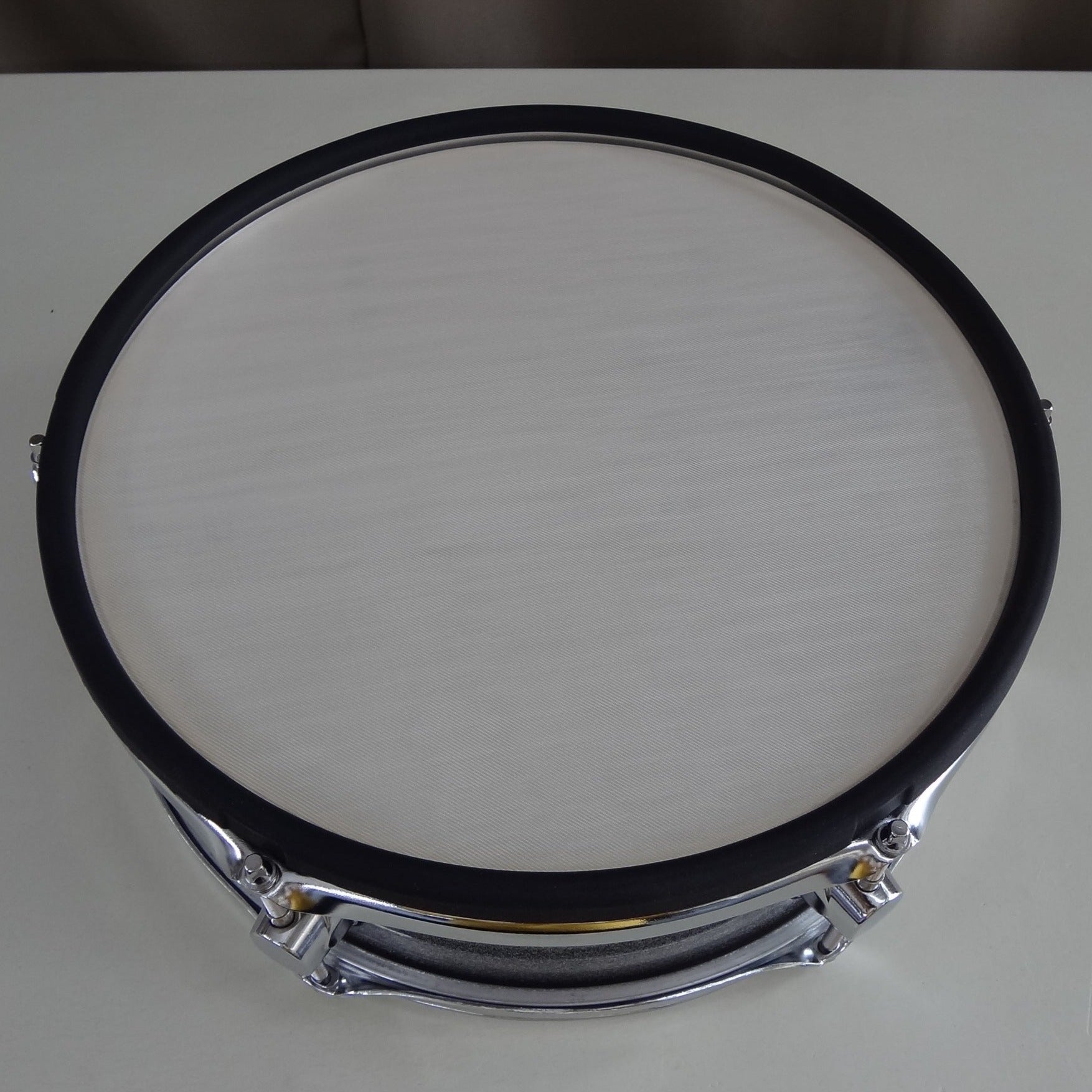 Top down rim view of new 13 inch custom electronic snare drum silver sparkle wrap