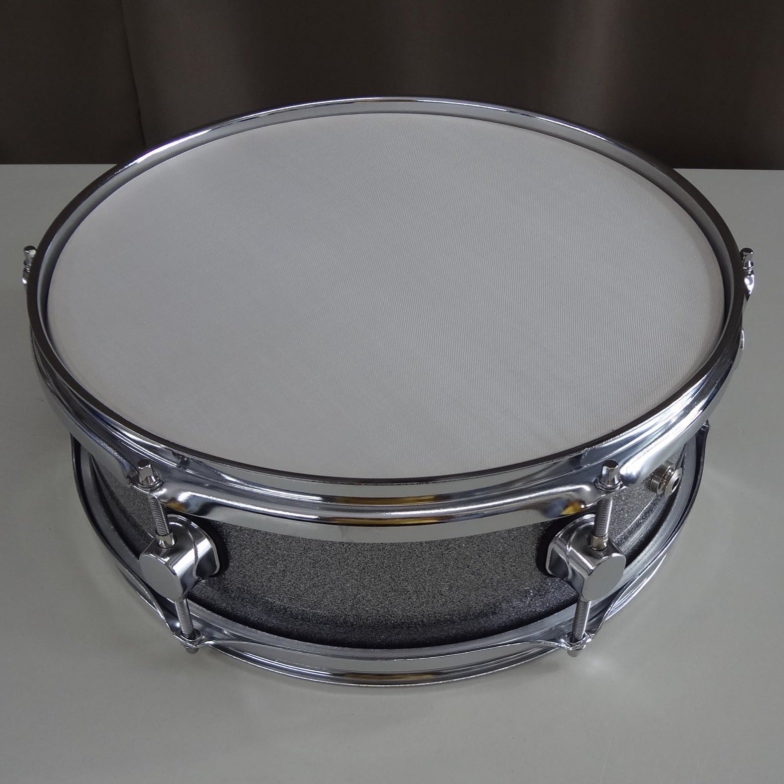 Top down view of new 13 inch custom electronic snare drum silver sparkle wrap